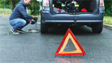 warning triangle with car in background 